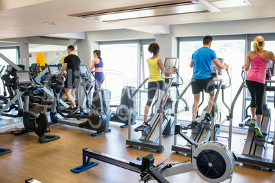 Fit people working out using machines