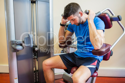 Concentrating man using weights machine