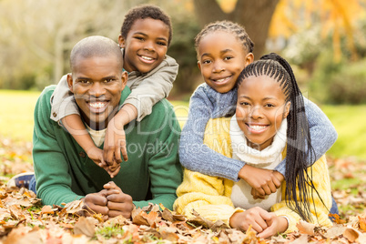 Portrait of a young family lying in leaves