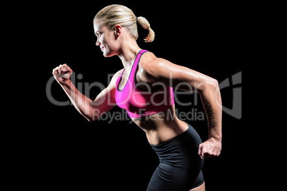 Muscular woman running in sportswear