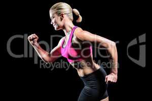 Muscular woman running in sportswear