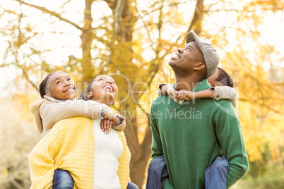 Portrait of a young smiling family in piggyback