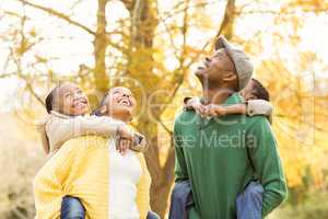 Portrait of a young smiling family in piggyback