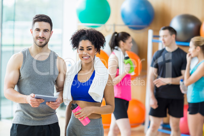 Client and trainer looking at tablet pc