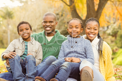 Portrait of a young family sitting in leaves