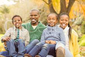 Portrait of a young family sitting in leaves