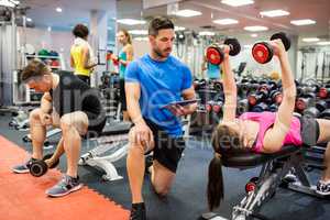 Fit people working out in weights room