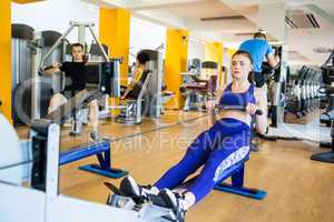 Fit woman using the rowing machine