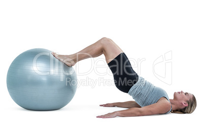 Muscular woman lying on floor with legs