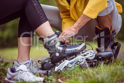 Happy couple putting on roller blades