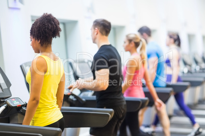 Fit people walking on treadmills