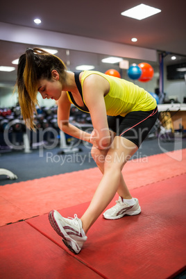 Woman massaging her injured leg