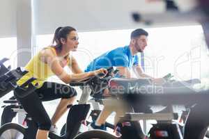 Couple using exercise bikes together