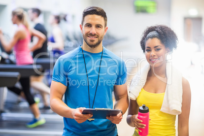 Trainer and client smiling at camera