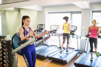 Fit people working out using machines