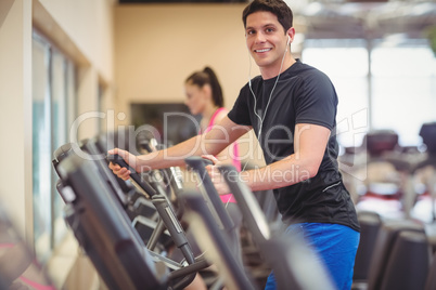 Fit people working out using machines