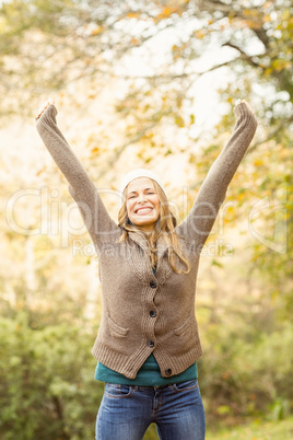 Smiling pretty woman with arms raised Smiling pretty woman with arms raised