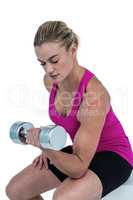 Muscular woman exercising with dumbbells