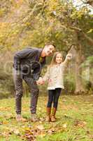 Cute daughter showing something to her father