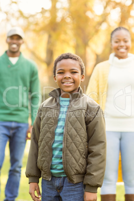 A little boy against his parents in the background