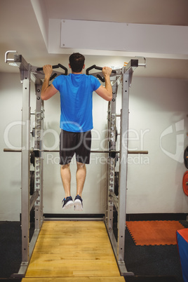 Fit man doing pull ups