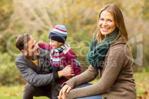 Smiling young couple with little boy posing