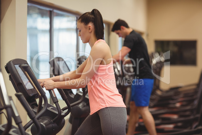 Fit people working out using machines