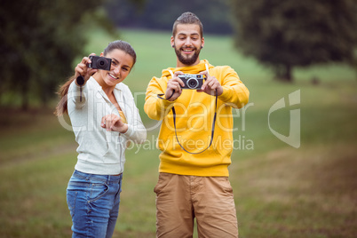 Happy couple taking photos to camera