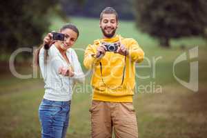 Happy couple taking photos to camera
