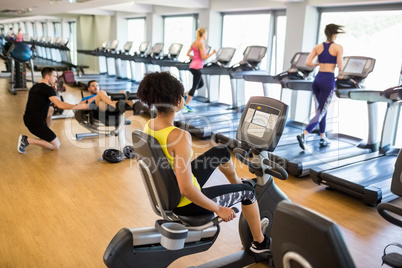 Fit people working out using machines