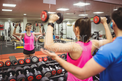 Fit couple working out in weights room