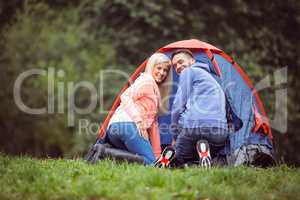 Happy couple setting up their tent