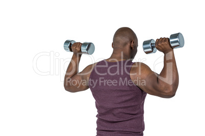 Fit man exercising with dumbbell