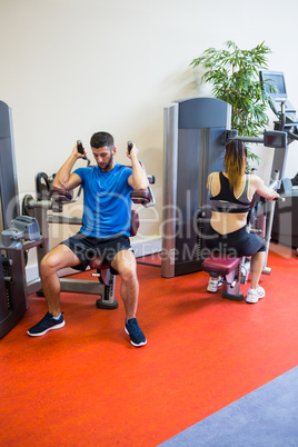 Fit man and woman working out