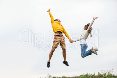 Couple jumping on a hike