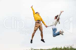 Couple jumping on a hike