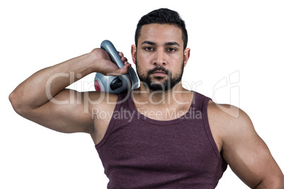 Muscular serious man holding a kettlebell Muscular serious man holding a kettlebell