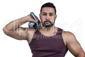 Muscular serious man holding a kettlebell