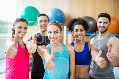 Fitness class smiling at camera in studio