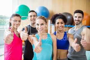 Fitness class smiling at camera in studio