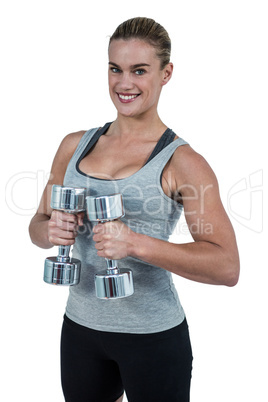 Muscular woman working out with dumbbells