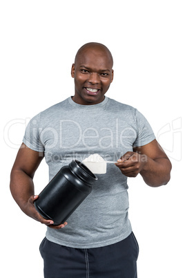 Fit man scooping protein powder