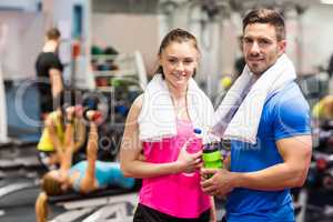 Fit couple smiling at camera