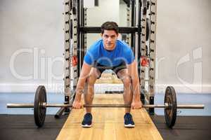 Focused man about to lift a barbell