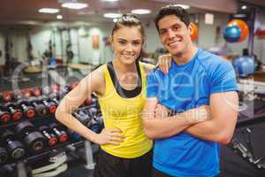 Fit couple smiling at camera