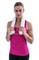 Muscular woman holding a towel around her neck
