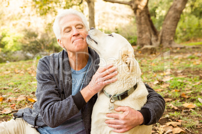 Senior man with his dog in park