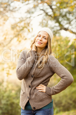 Smiling pretty woman posing with hand on hips