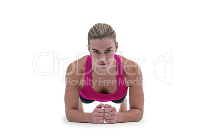 A muscular woman on a plank position