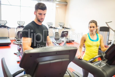 Couple using treadmills together